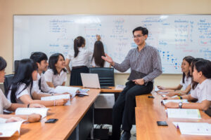 Asian teacher Giving Lesson to group of College Students in the classroom, University education concept